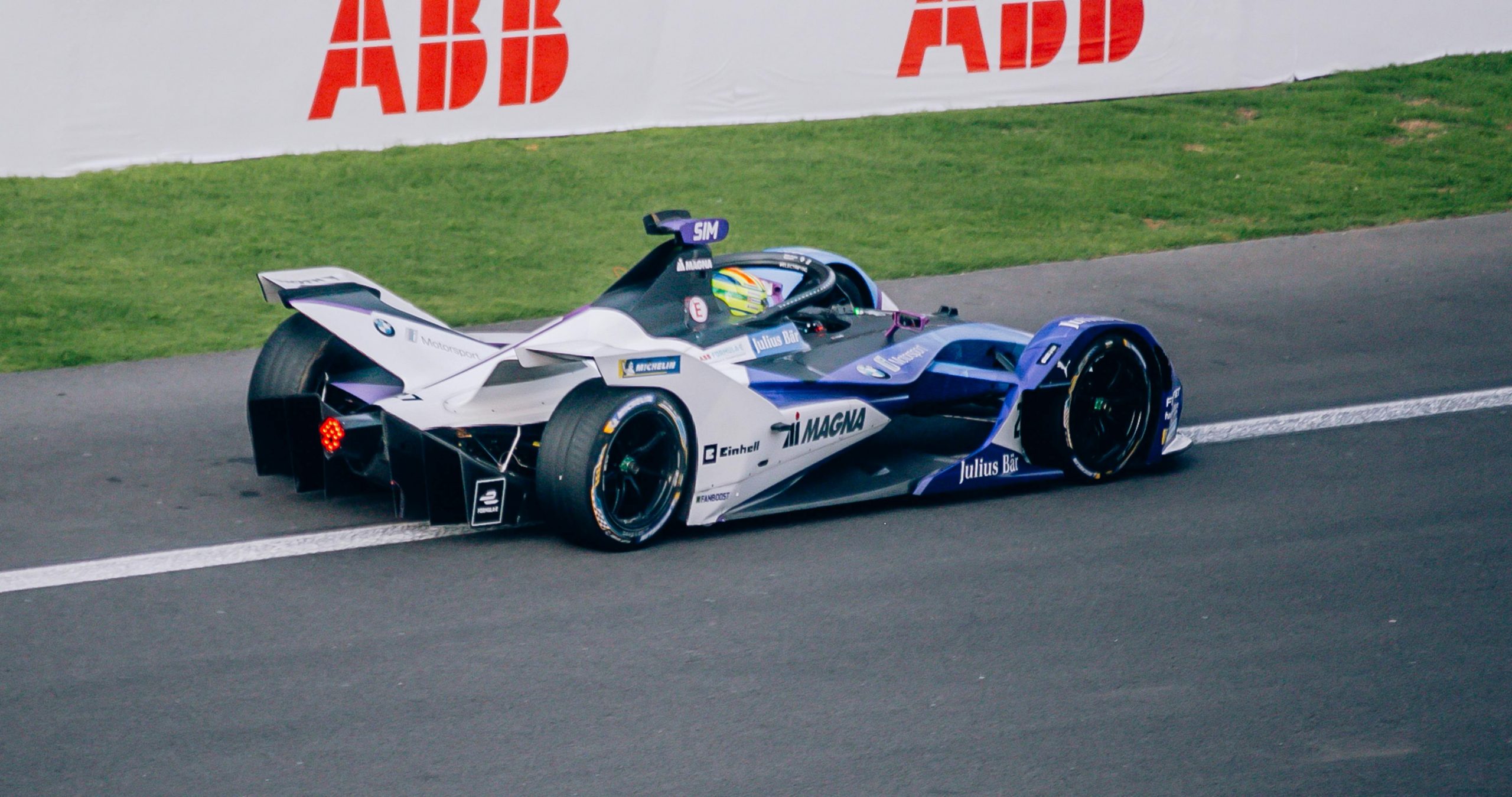 blue and white Formula 1 race car on a track