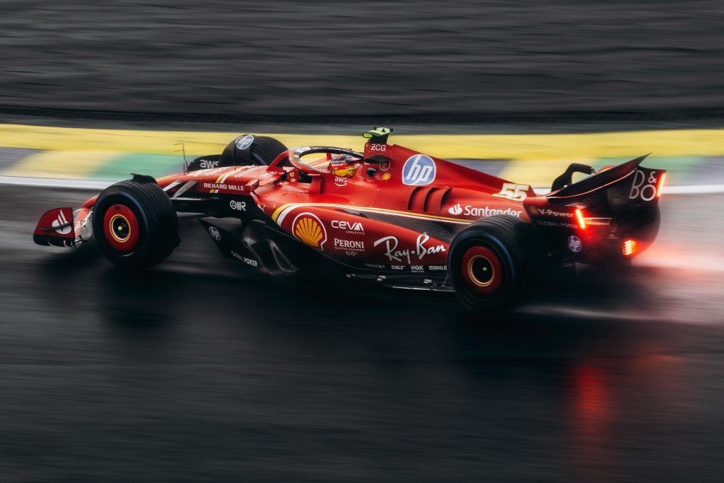 red Formula 1 race car on a wet track