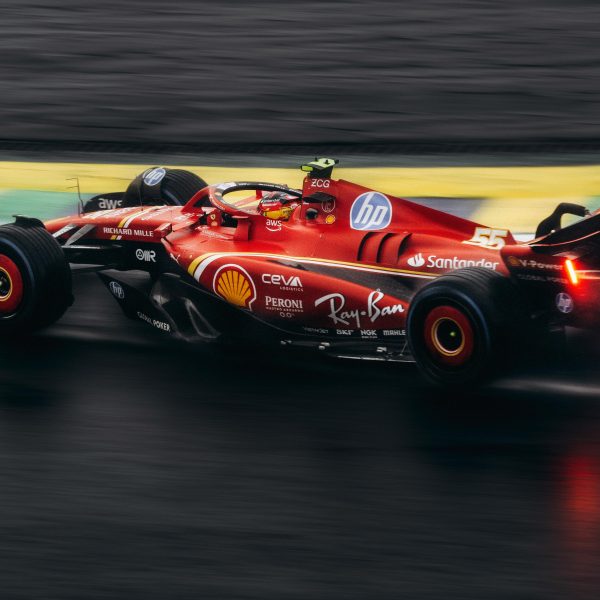 red Formula 1 race car on a wet track