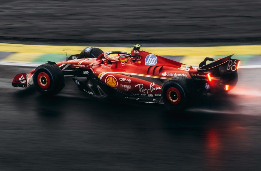 red Formula 1 race car on a wet track